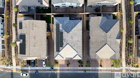 A bird's eye view of a street with cars and buildings.
