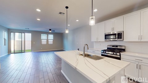 A modern kitchen with white cabinets and a large island.