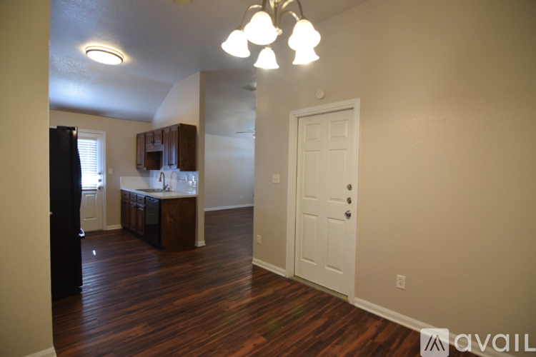 A kitchen with wooden floors and white walls.