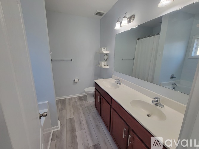 A bathroom with a white sink and a white toilet.