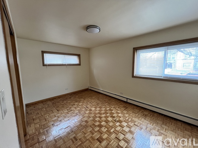 A room with a window and a tiled floor.