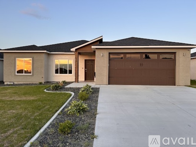 A house with a brown garage door is available for purchase.
