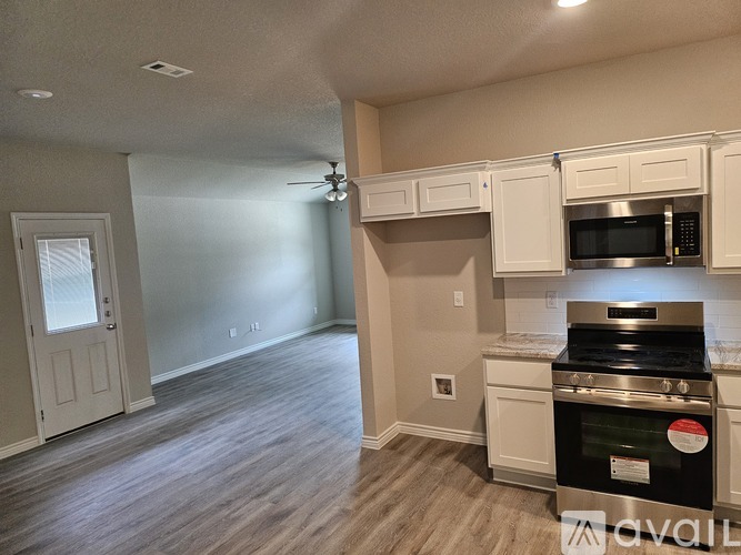 A kitchen with a stove top oven and microwave.