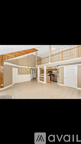 A room with a balcony and a door leading to another room.