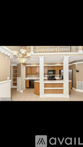 A kitchen with a white fridge and a white cabinet.
