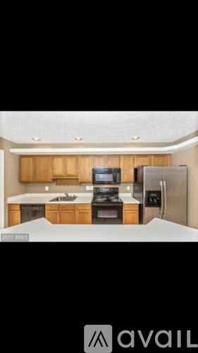 A kitchen with wooden cabinets and stainless steel appliances.