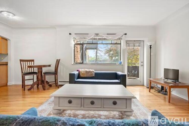 A living room with a blue couch and a wooden coffee table.