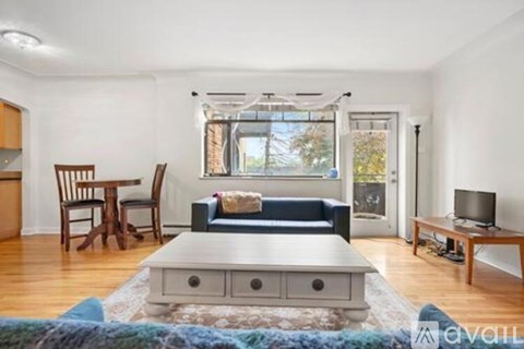 A living room with a blue couch and a wooden coffee table.