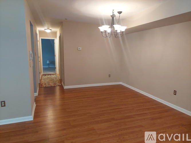 A room with wooden floors and a chandelier.