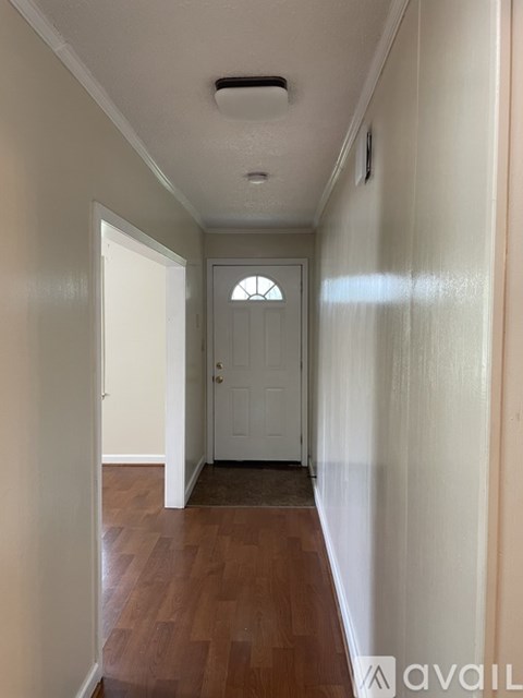 A long hallway with a door at the end.