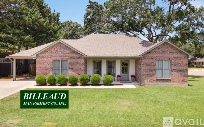 A brick house with the name Billeaud Management Co. Inc. on the lawn.