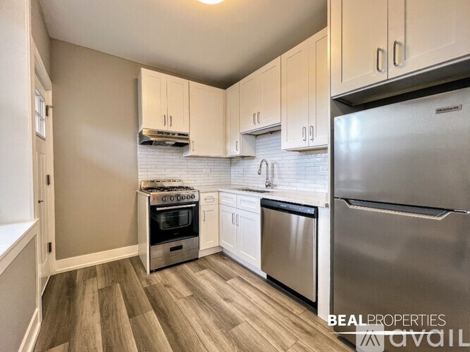 A kitchen with a stainless steel refrigerator and oven.
