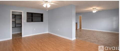 A room with a wooden floor and a sliding barn door.