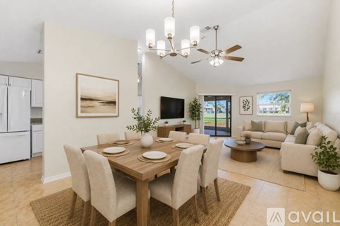 A modern dining room with a wooden table and chairs, a ceiling fan, and a large window.