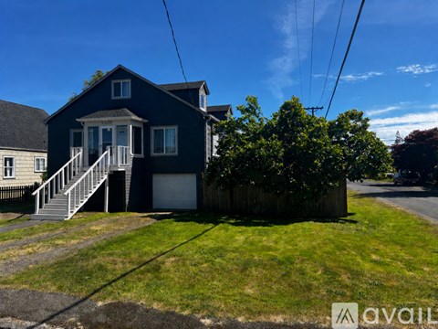 A blue house with a white door and windows.