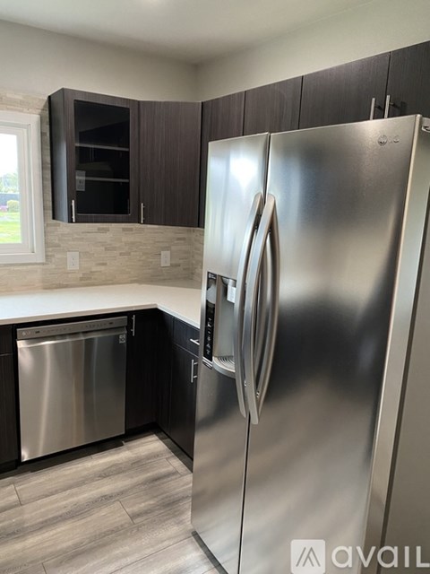 A kitchen with a stainless steel refrigerator and a dishwasher.