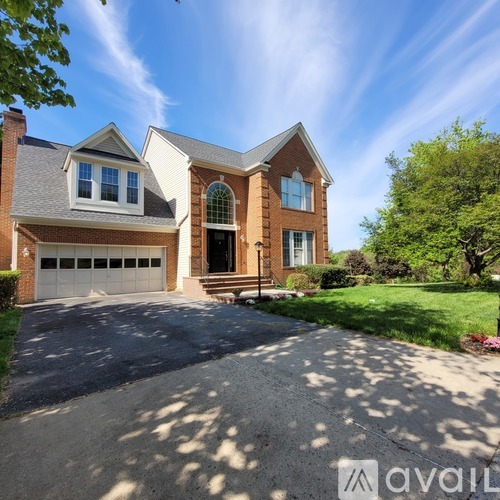 A house with a driveway and a garage is for sale.