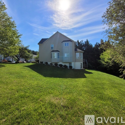 A house with a large lawn in front of it is for sale.
