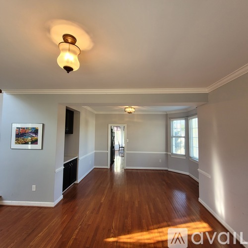 A room with wooden floors and a light on the ceiling.