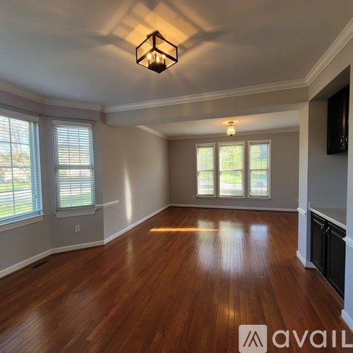 A room with wooden floors and a ceiling light.