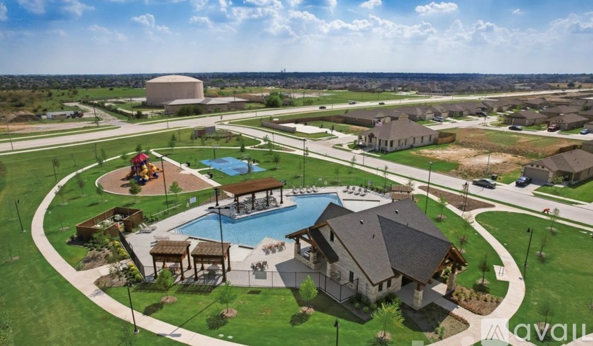 A bird's eye view of a residential area with houses, a swimming pool, and a playground.