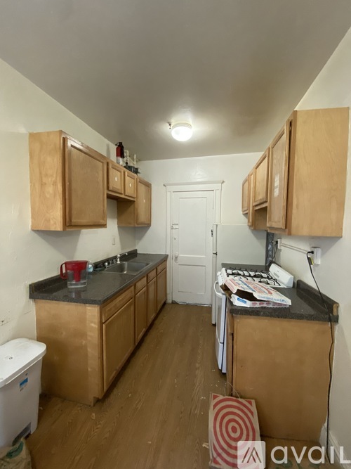 A kitchen with wooden cabinets and a white door.