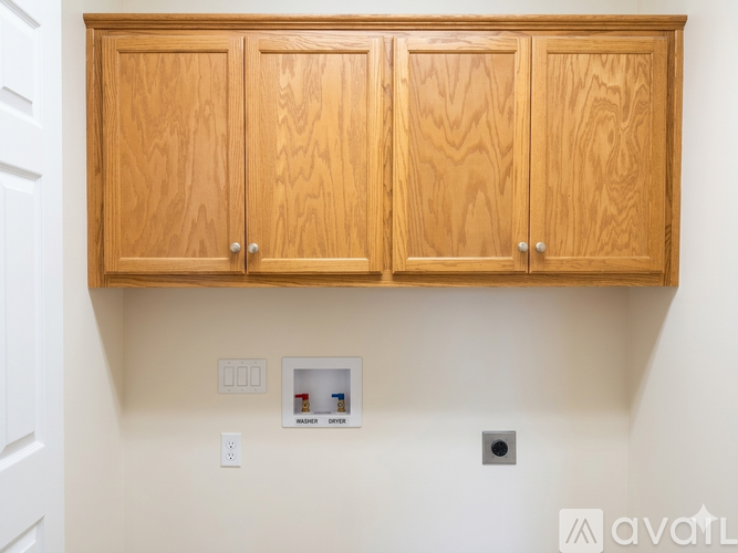 A wooden cabinet with a switch for the lights and a switch for the outlet.