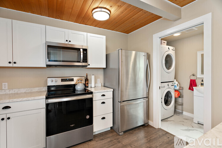 A kitchen with white cabinets and stainless steel appliances.