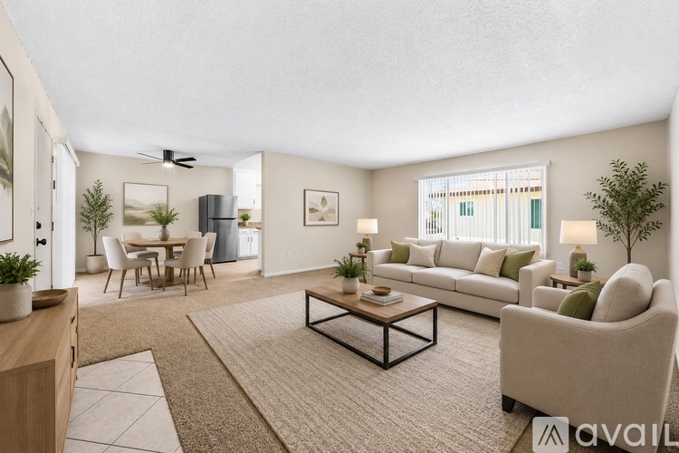 A living room with a couch, chairs, and a coffee table.