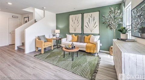 A living room with a white couch and a green rug.