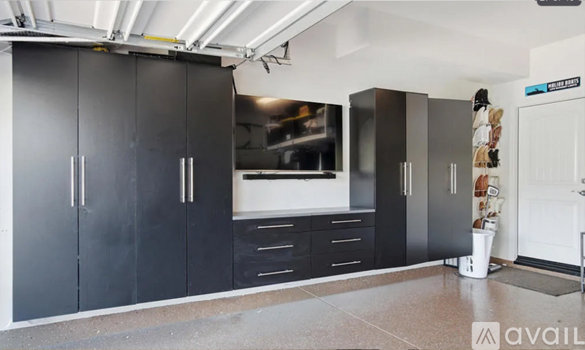 A kitchen with black cabinets and a white countertop.