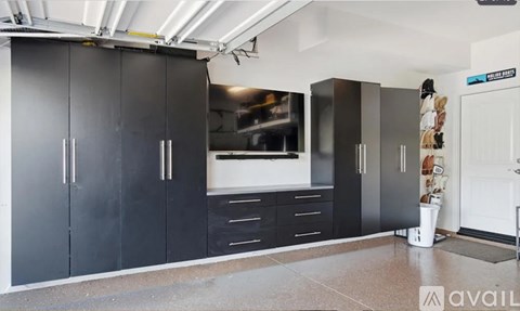 A kitchen with black cabinets and a white countertop.