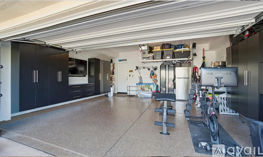 A spacious garage with a variety of equipment and tools.