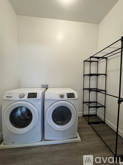 Two front loading washing machines in a laundry room.