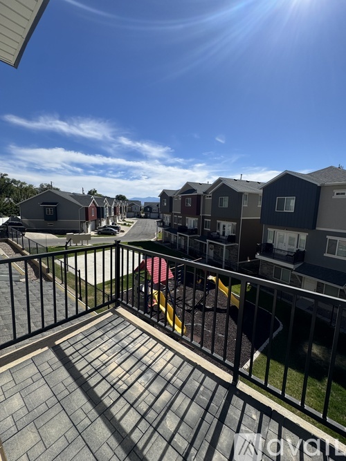 A sunny day in a residential area with houses and a clear blue sky.