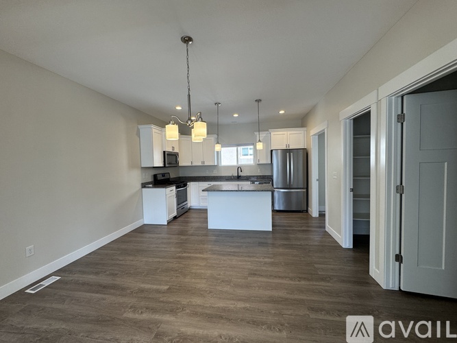 A spacious kitchen with white cabinets and a center island.
