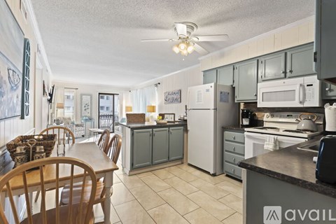 A kitchen with a table and chairs.