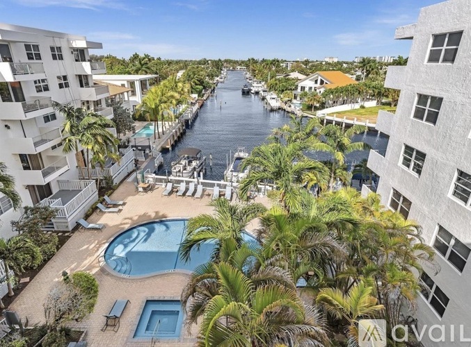 A view of a pool and a canal from a balcony.
