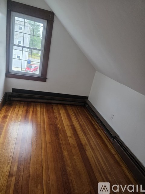 A room with wooden floors and a window.