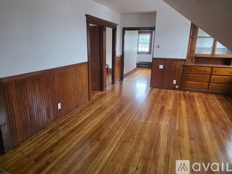 A room with wooden floors and a wooden wall.