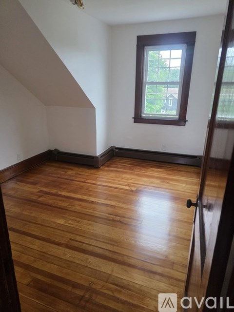A room with wooden floors and a window.