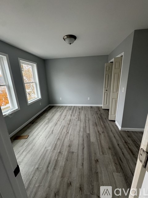 A room with grey walls and wooden flooring.