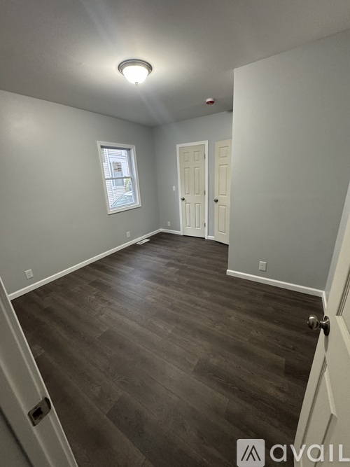 A room with a wooden floor and white walls.