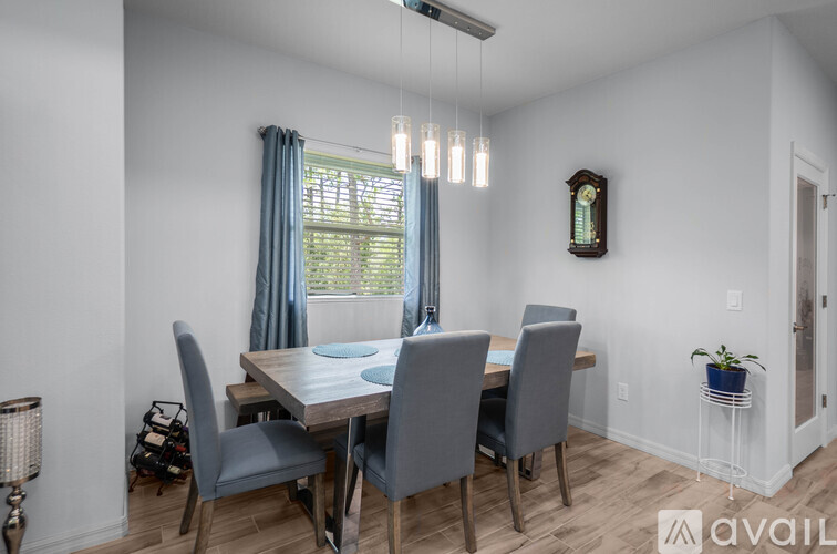 A dining room with a table and chairs.