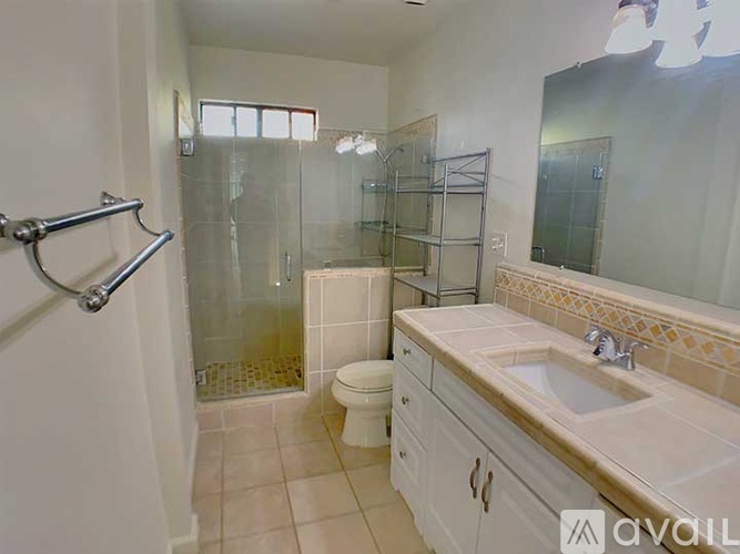 A bathroom with a toilet, sink, and shower.