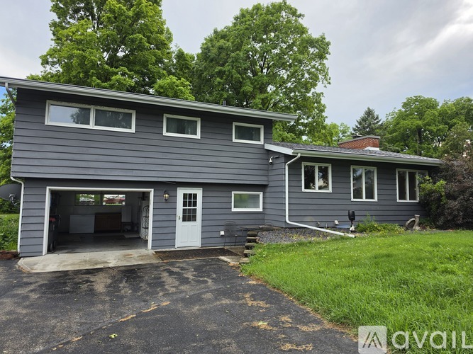 A two-story house with a garage is available for rent.
