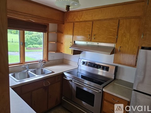 A kitchen with wooden cabinets and stainless steel appliances.