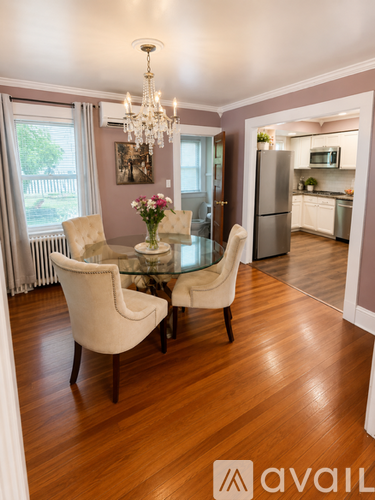 A dining room with a glass table and chairs.