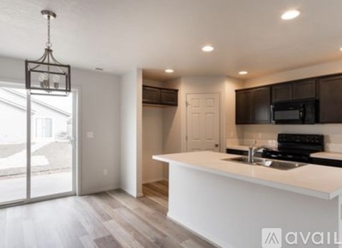 A modern kitchen with a white countertop and dark brown cabinets.
