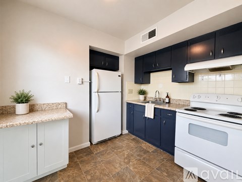 A kitchen with a white refrigerator and a white stove.